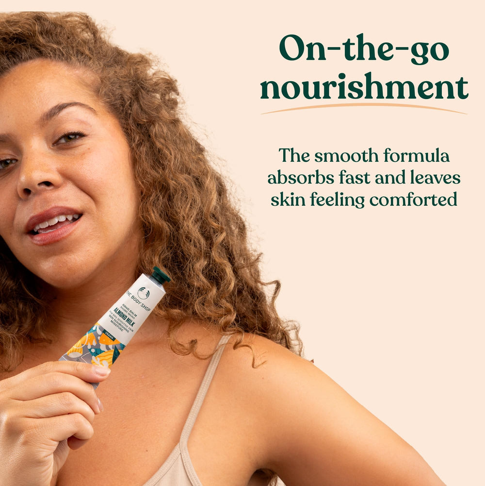 The Body Shop hand balm held in a hand to show 1.0 fl oz scale benefit: travel-size convenience