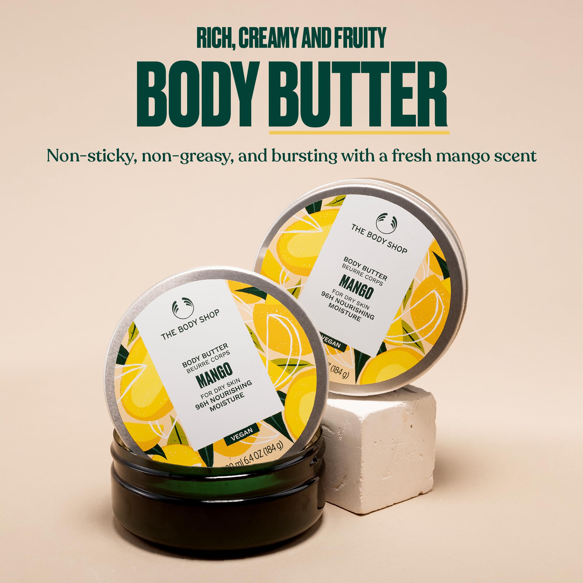 The Body Shop mango body butter open tub texture showing creamy butter for intense moisturising