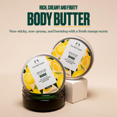 The Body Shop mango body butter open tub texture showing creamy butter for intense moisturising