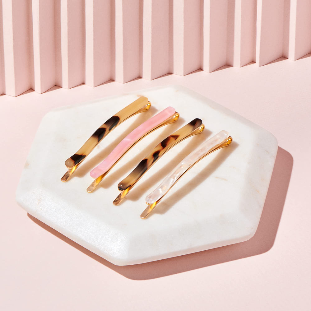 The Hair Edit pins held in hand illustrating slim scale and easy portability