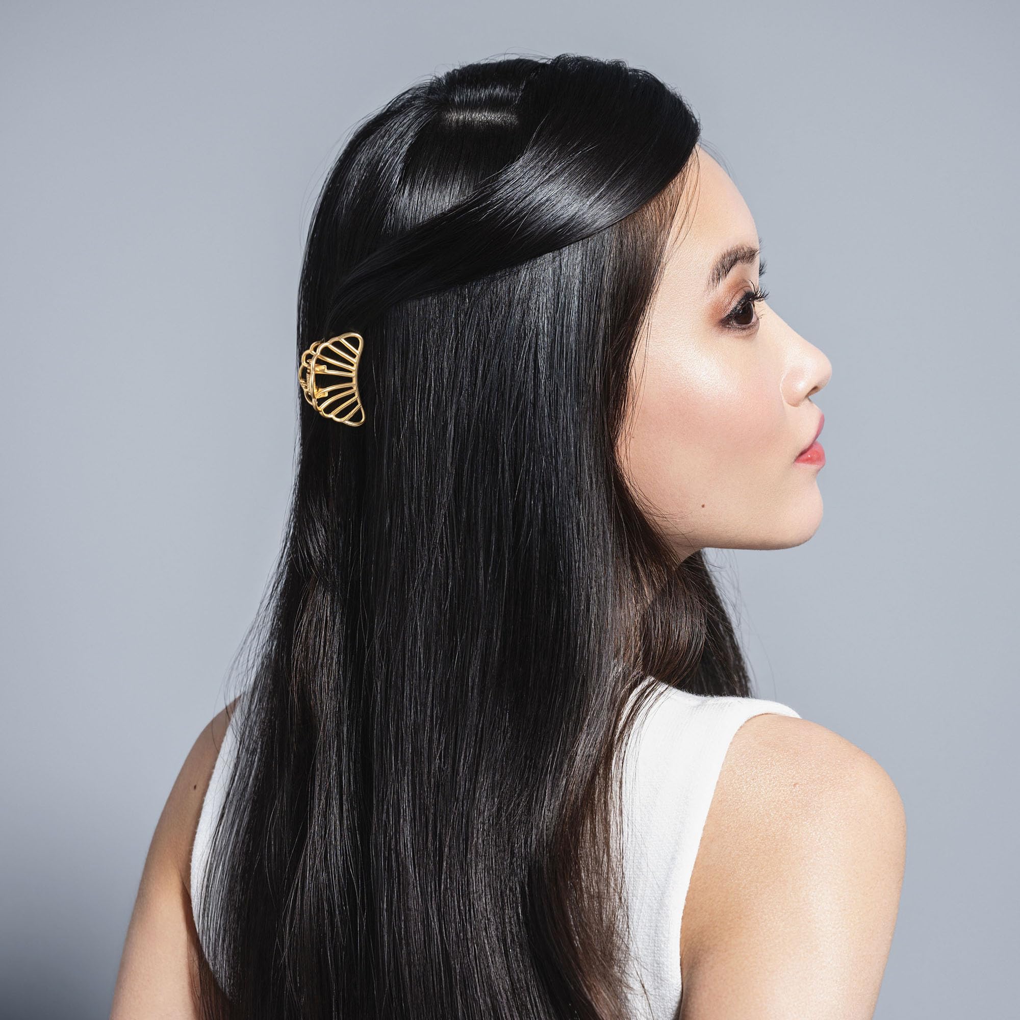 The Hair Edit scale comparison in hand showing petite, lightweight benefit