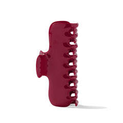 The Hair Edit scarlet claw clip in hand to show scale and comfortable size