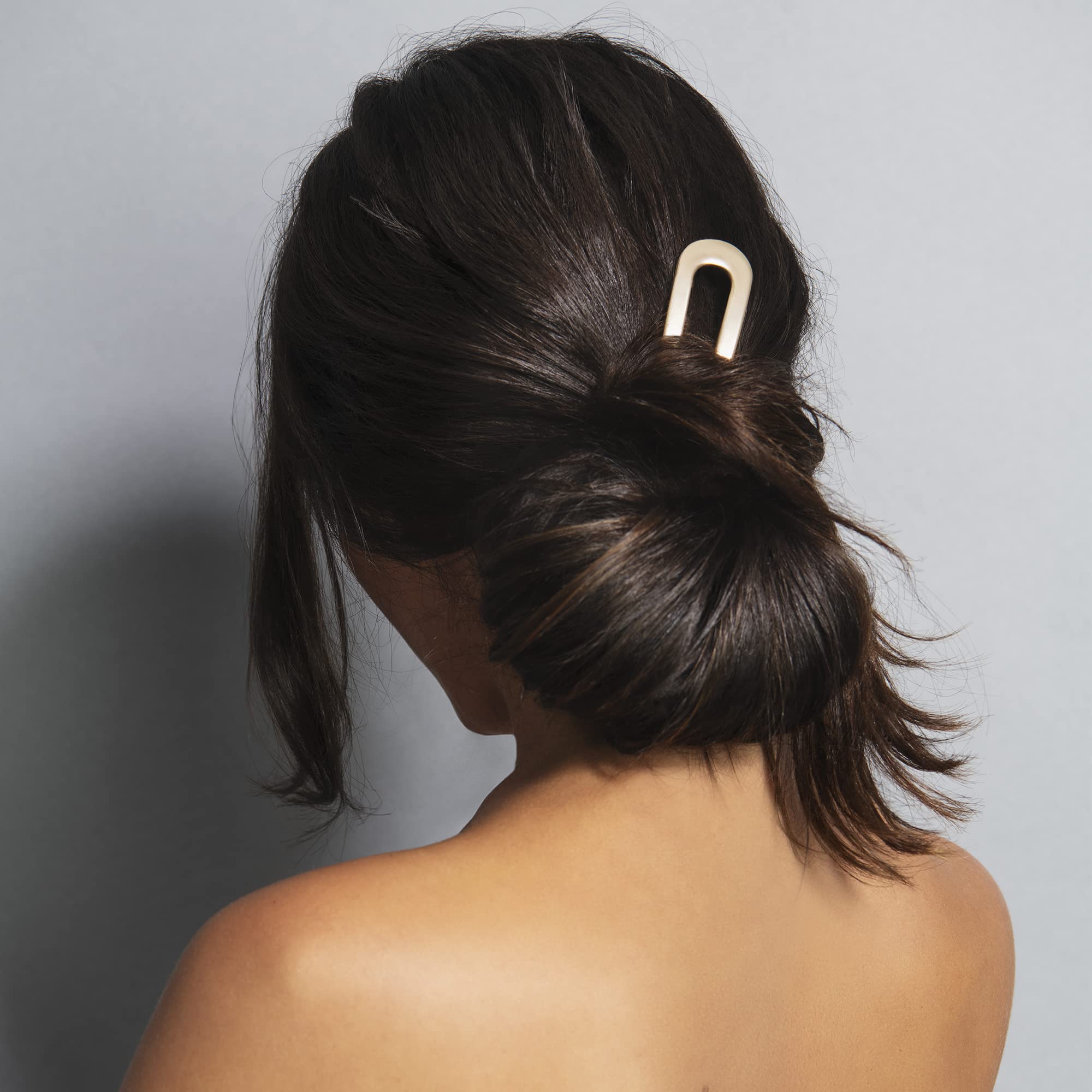 The Hair Edit close-up shows soft gold finish and smooth surface for gentle hold benefit