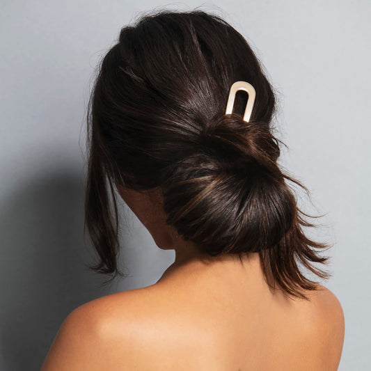 The Hair Edit close-up shows soft gold finish and smooth surface for gentle hold benefit
