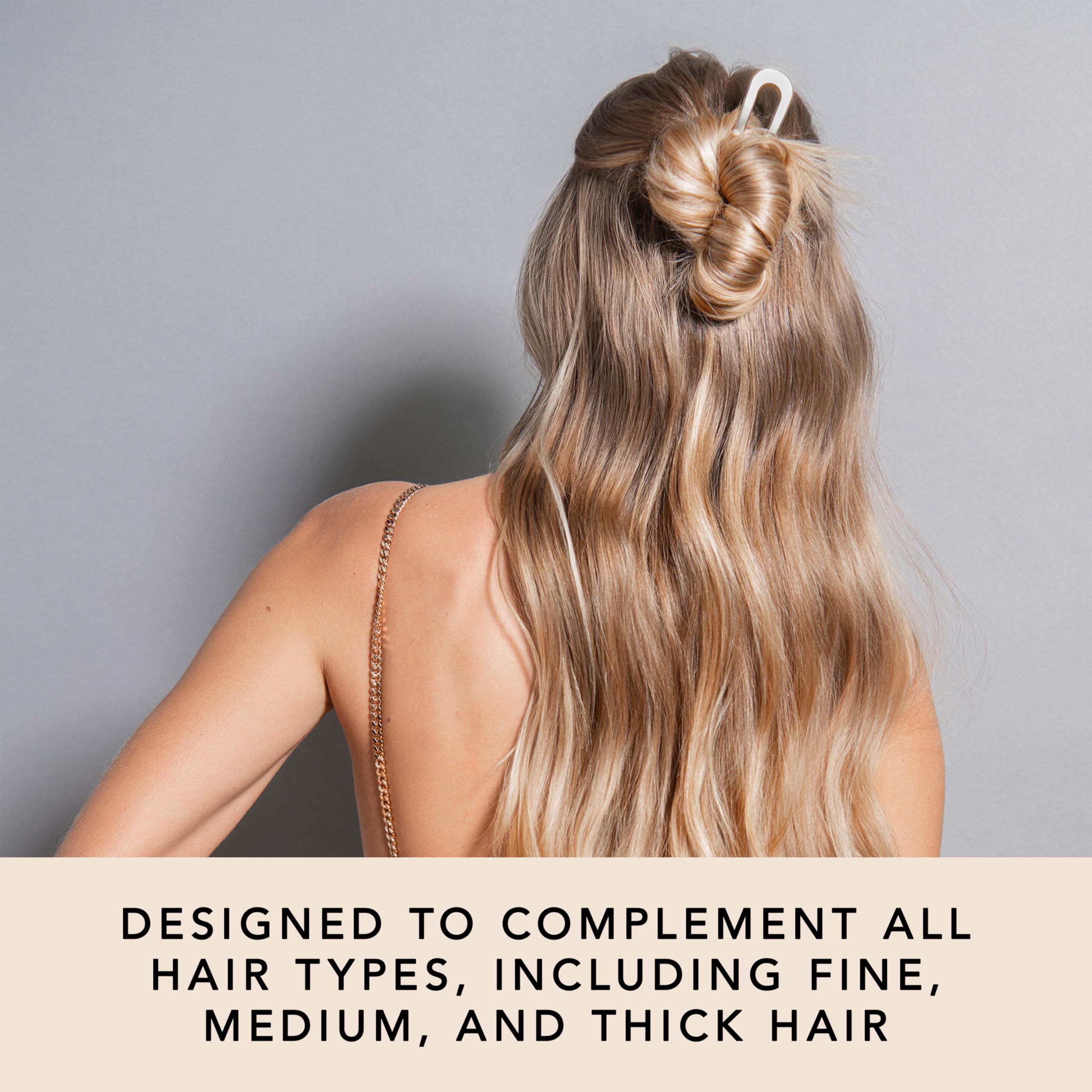 The Hair Edit pin securing a low bun in use conveys quick updo styling benefit
