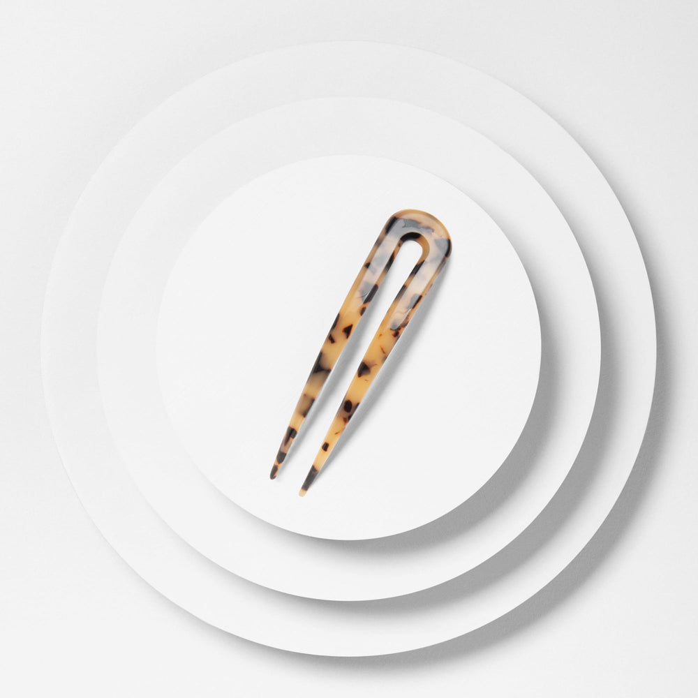 The Hair Edit beside coin shows compact size and travel-friendly convenience