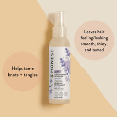 The Honest Company spray in hand demonstrating easy application and quick combing benefit