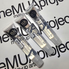 The Make-Up Artist Project tube next to coin showing compact travel-friendly size