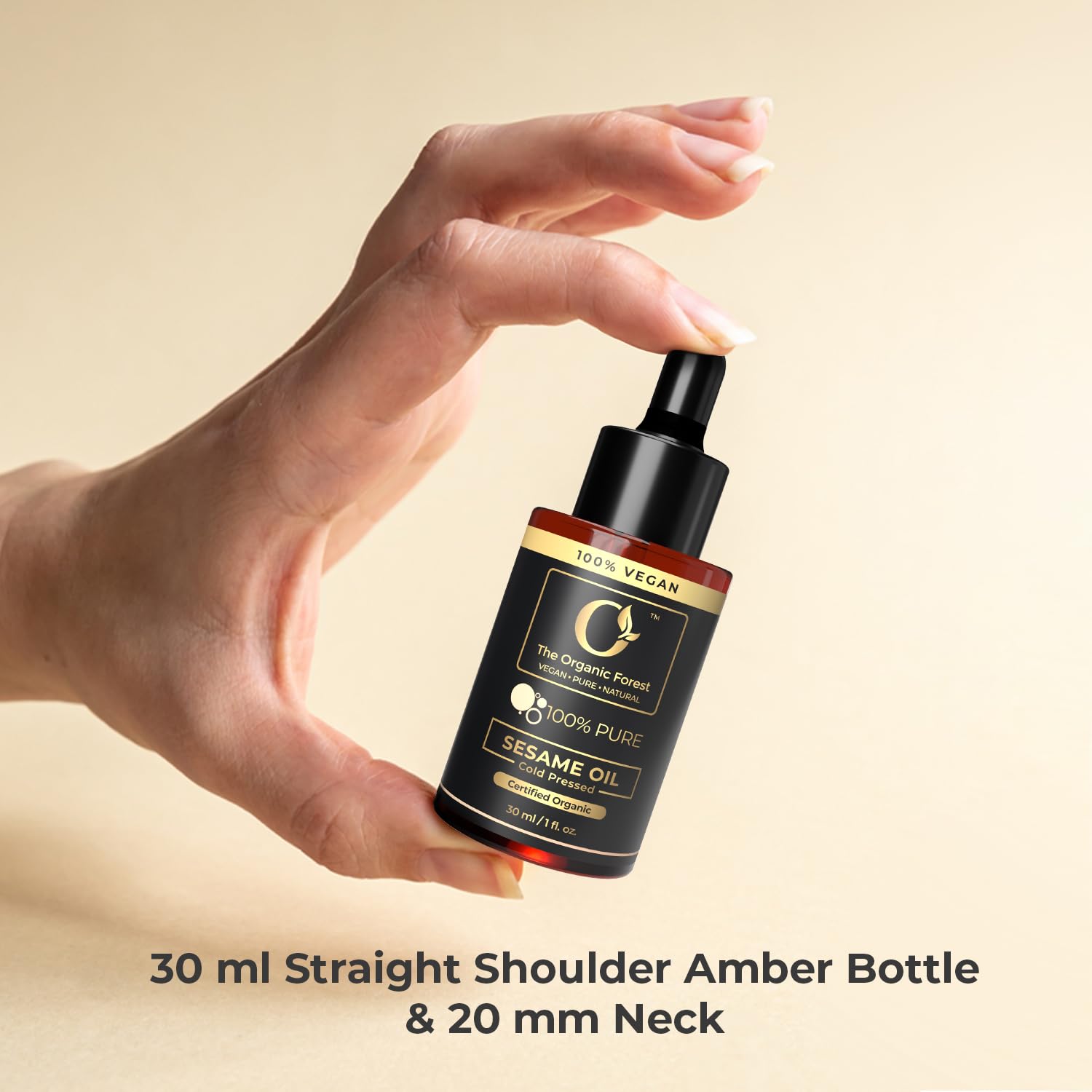 The Organic Forest sesame oil next to coin size comparison highlighting travel-friendly benefit
