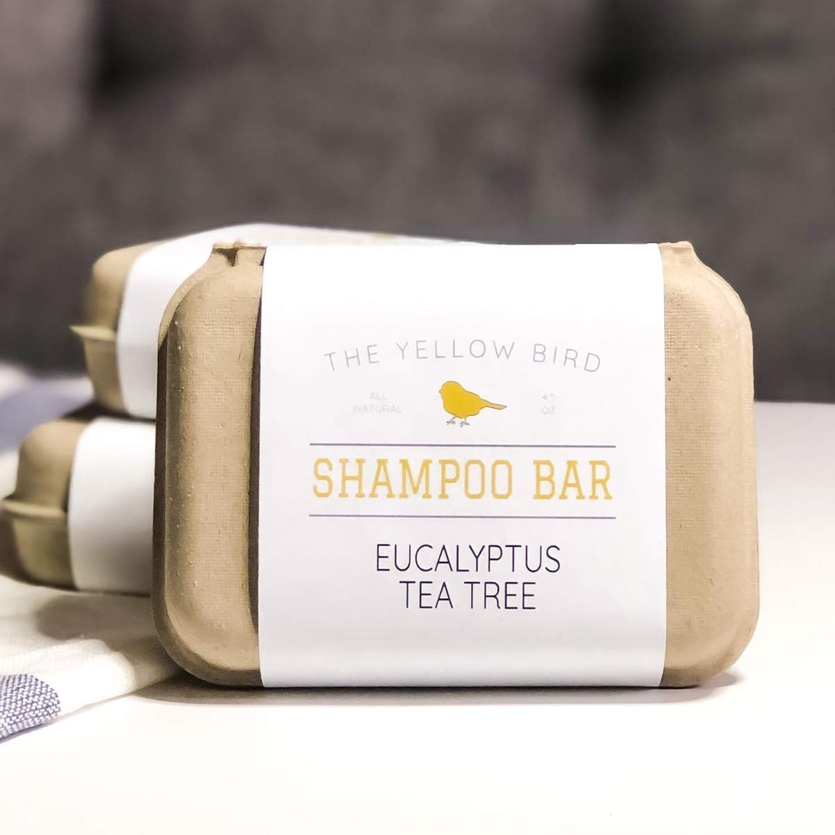 The Yellow Bird shampoo bar on bathroom shelf suggesting sustainable, zero-waste routine