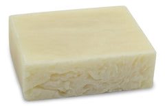 Hand holding The Yellow Bird soap bar showing size and easy grip for face and body cleansing