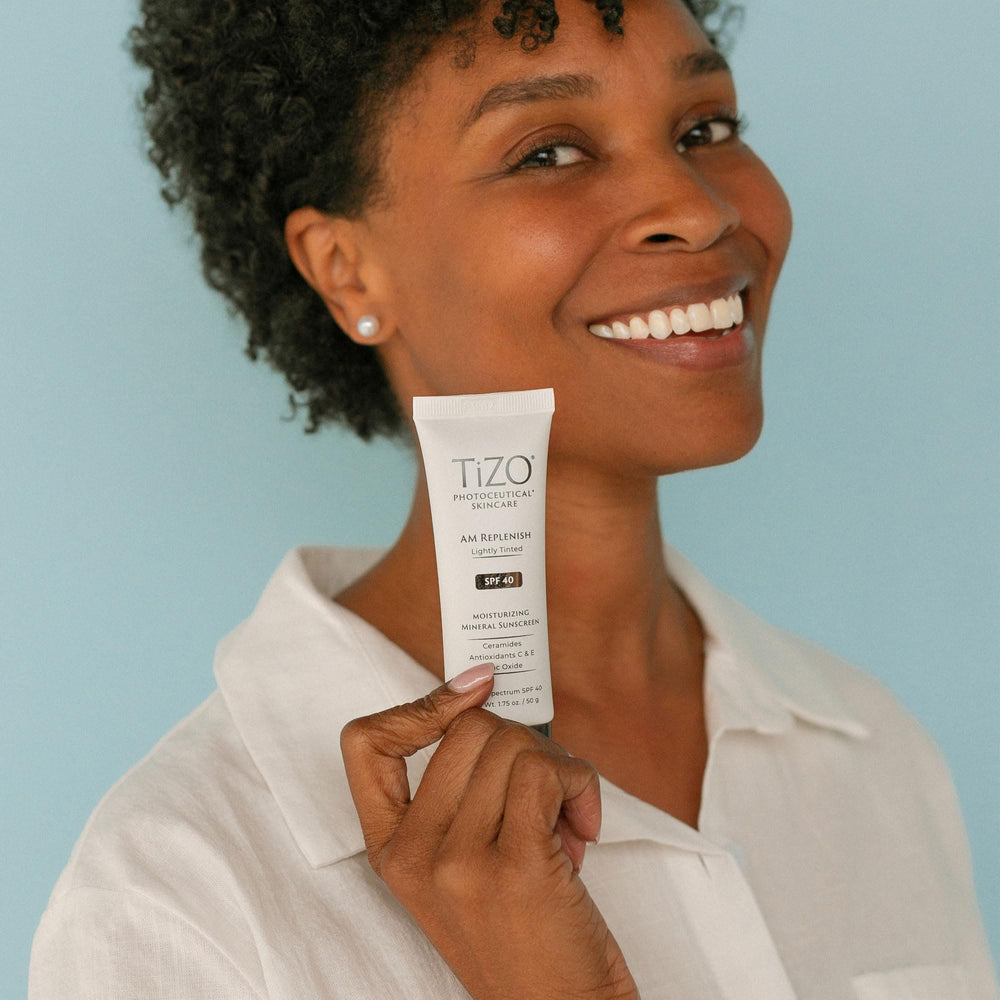 TIZO tube held in hand indicating size and easy daily use convenience