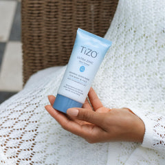 TIZO applying sunscreen to face demonstrating non-tinted finish