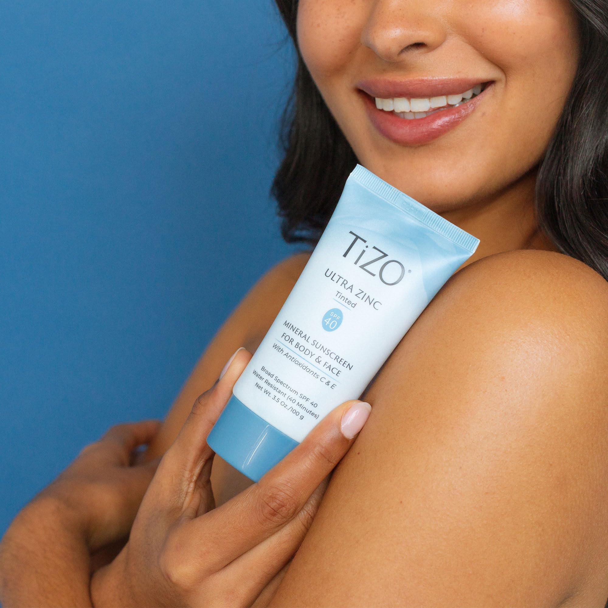 TIZO sunscreen drops on skin illustrating moisturizing, non-greasy feel