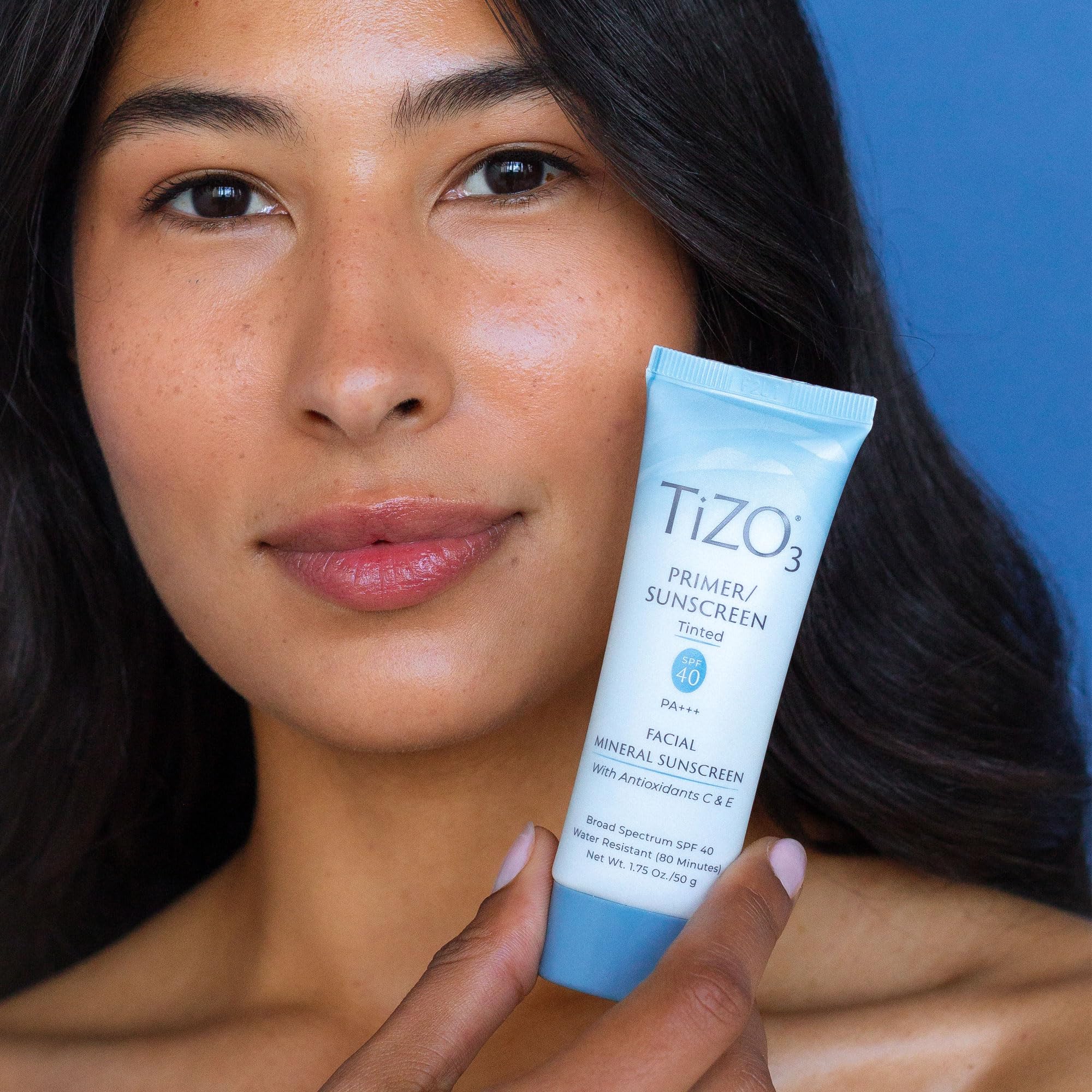 TIZO next to ruler showing 1.75 oz size and travel-friendly benefit
