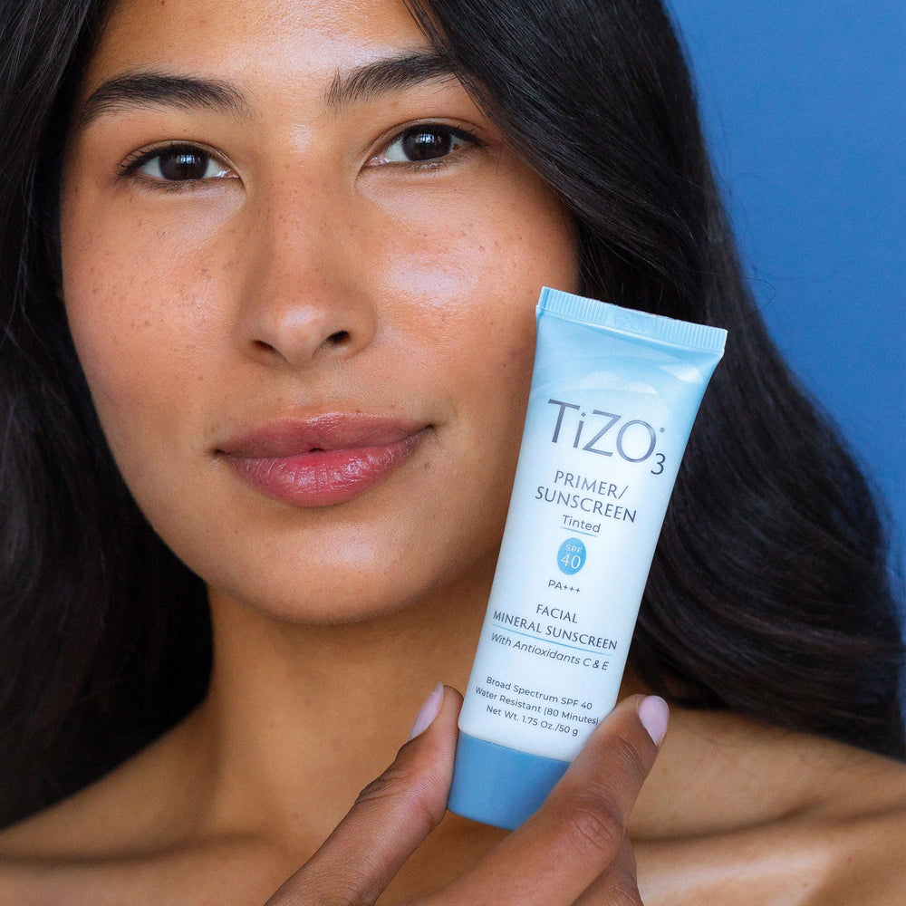 TIZO next to ruler showing 1.75 oz size and travel-friendly benefit