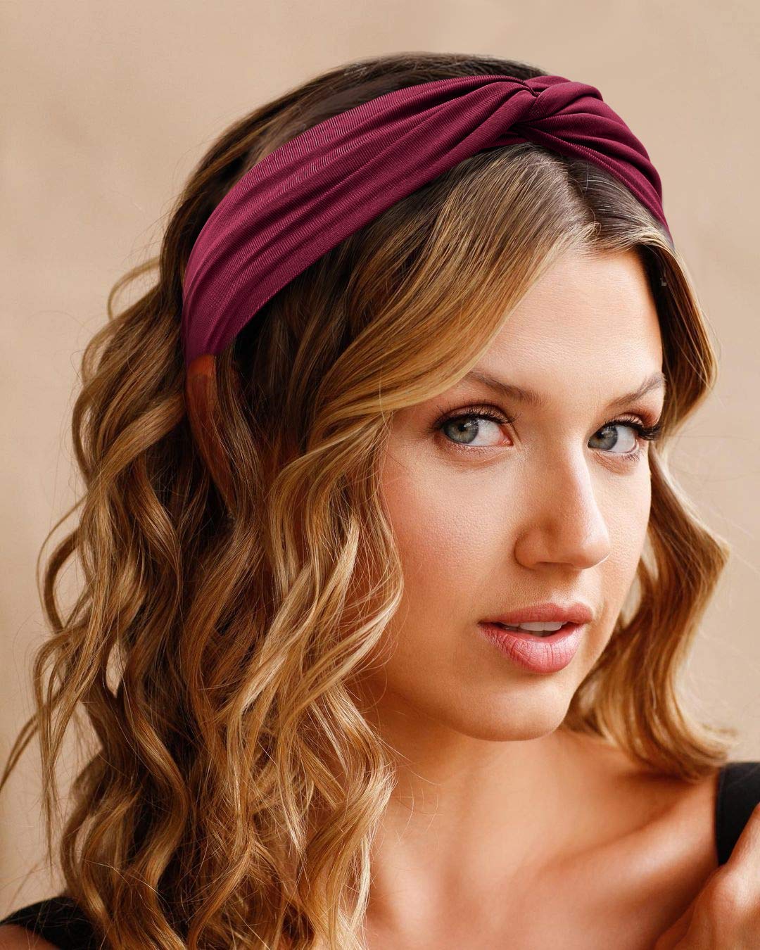 Tobeffect headband beside hand showing stretchy size and scale