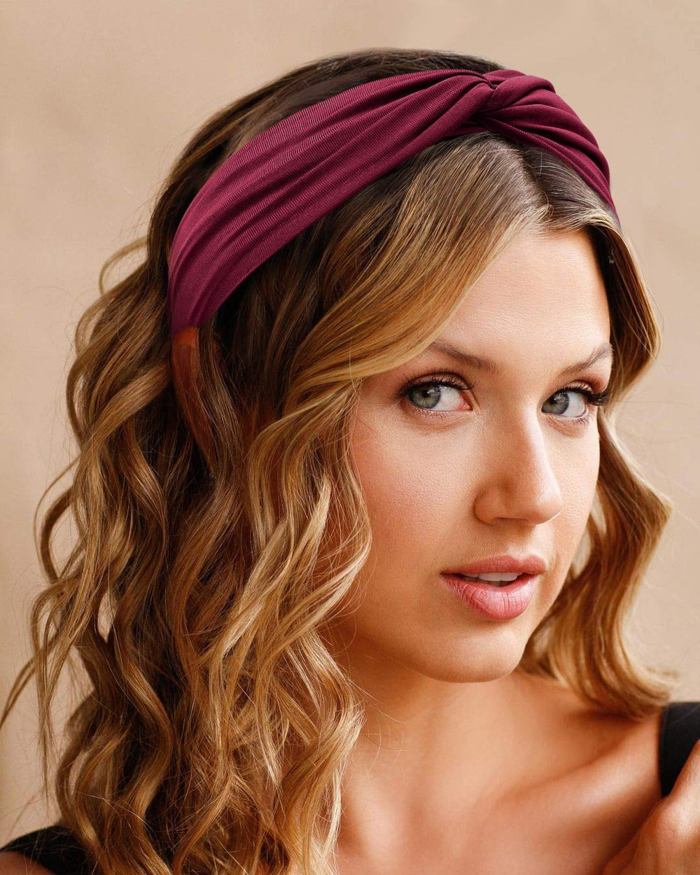 Tobeffect headband beside hand showing stretchy size and scale