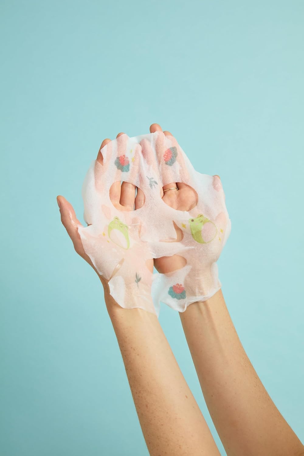 TONYMOLY mask held in hand showing single-use scale and travel-friendly convenience
