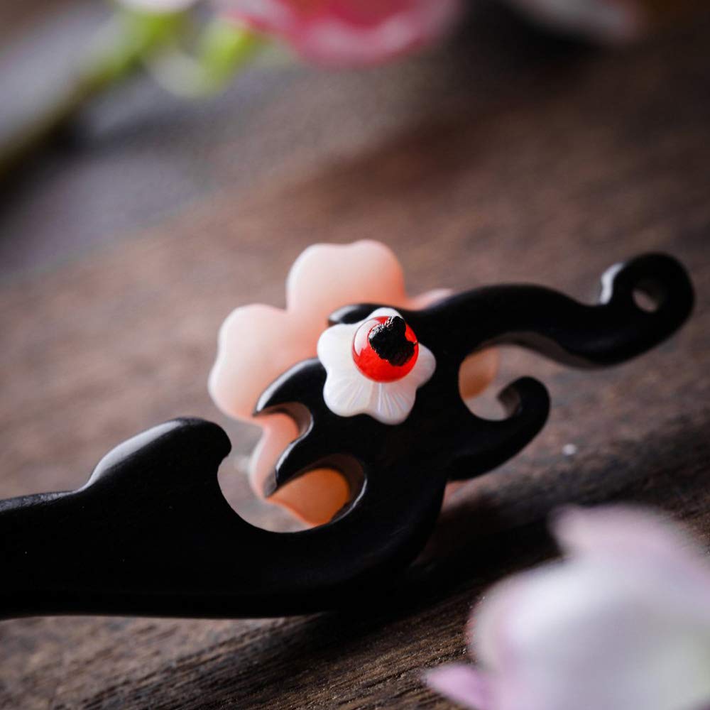 TOP SEWING hairpin inserted in bun shows secure hold and elegant retro look