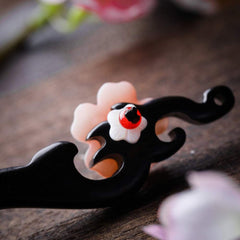TOP SEWING hairpin inserted in bun shows secure hold and elegant retro look