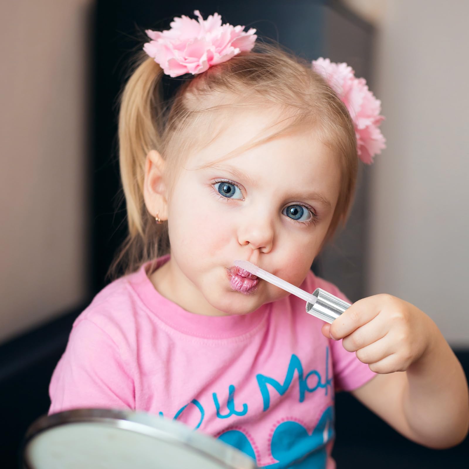 Child holding Townley Girl gloss demonstrating easy use and safe play