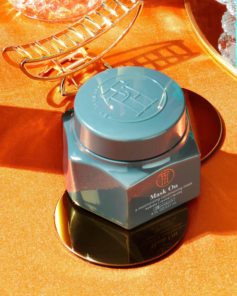 TPH by Taraji mango fruit beside jar emphasizing fresh tropical scent benefit