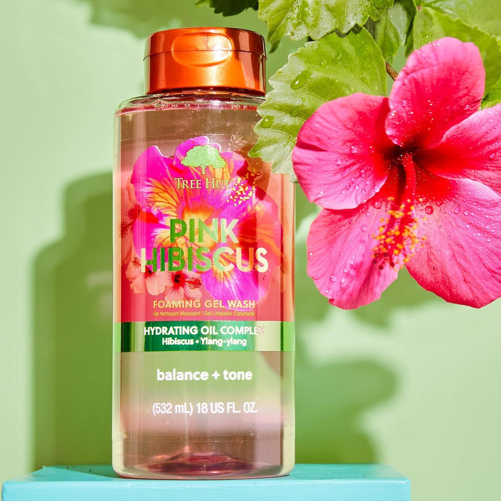 Tree Hut body wash on a shower pouf showing rich suds and soft skin benefit