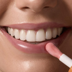 Tree Hut lip oil on lips demonstrating sheer pink tint and hydrated look