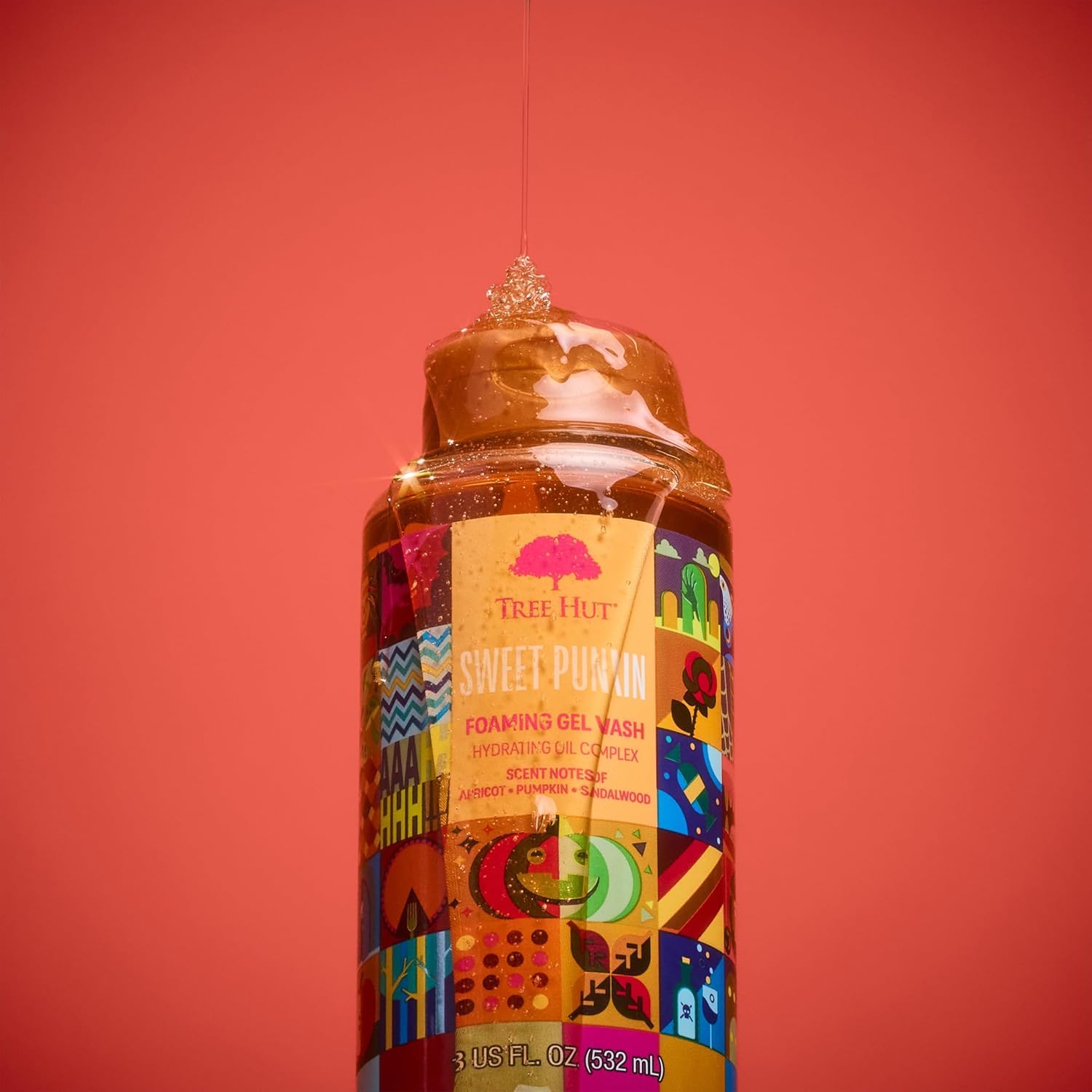 Tree Hut bottle next to hand showing 18 fl oz size and travel convenience