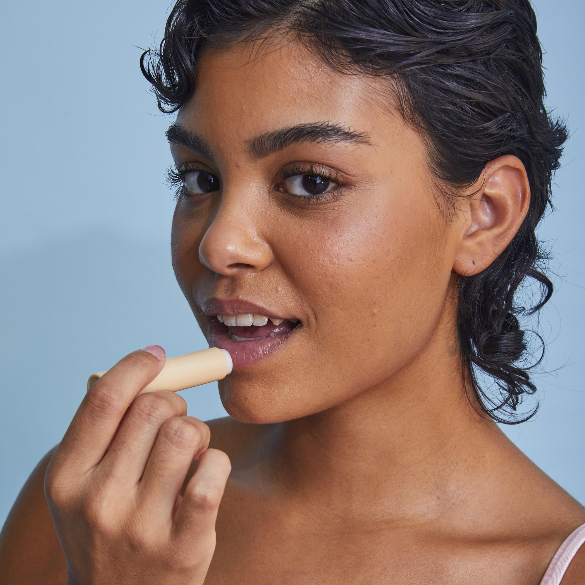 Tree Hut lip scrub stick in hand demonstrating easy mess-free application