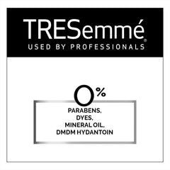 TRESemmé bottles beside a passport to show travel-size TSA friendliness