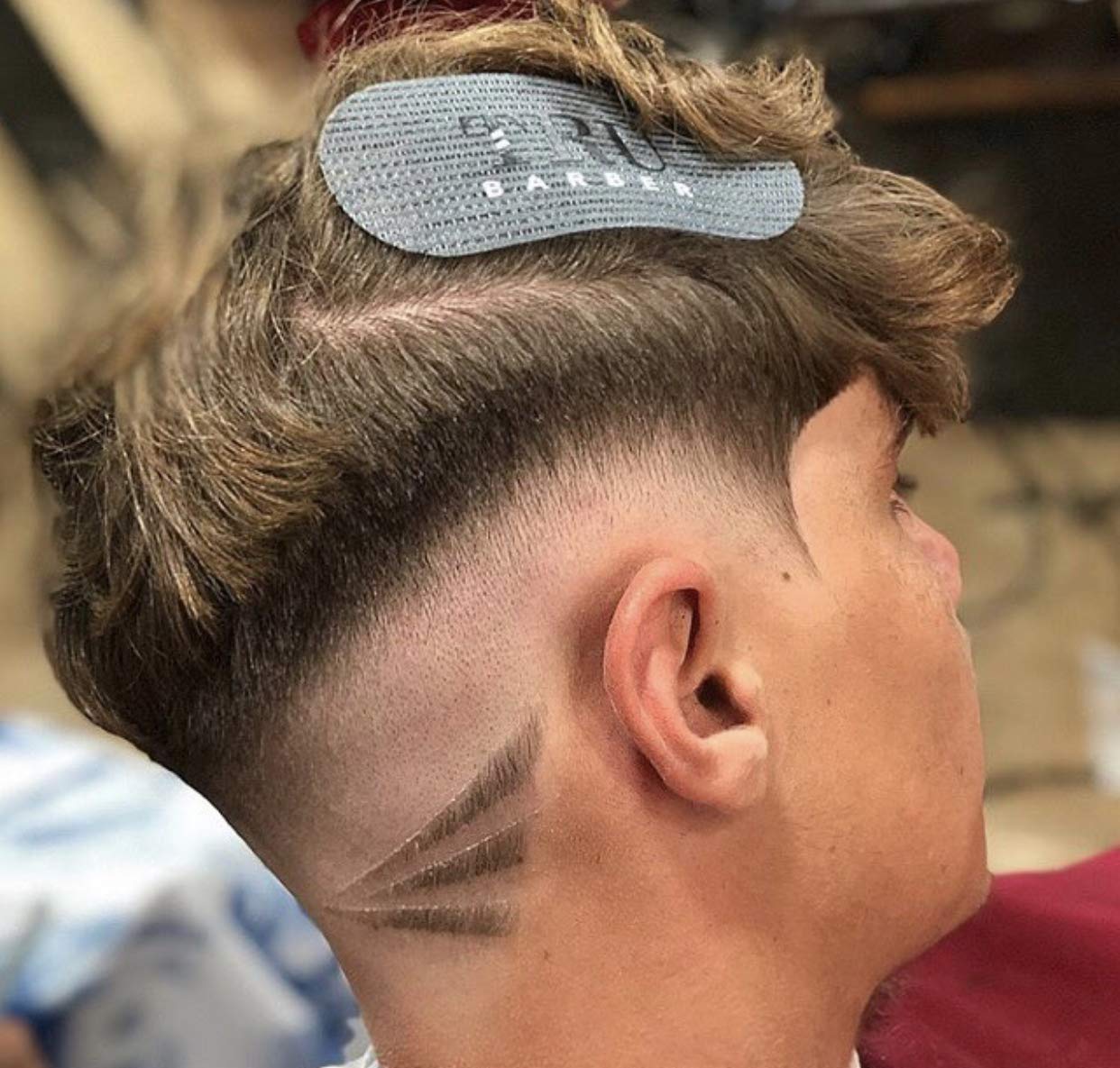 TRU BARBER clip holding a hair section during styling, showing professional control