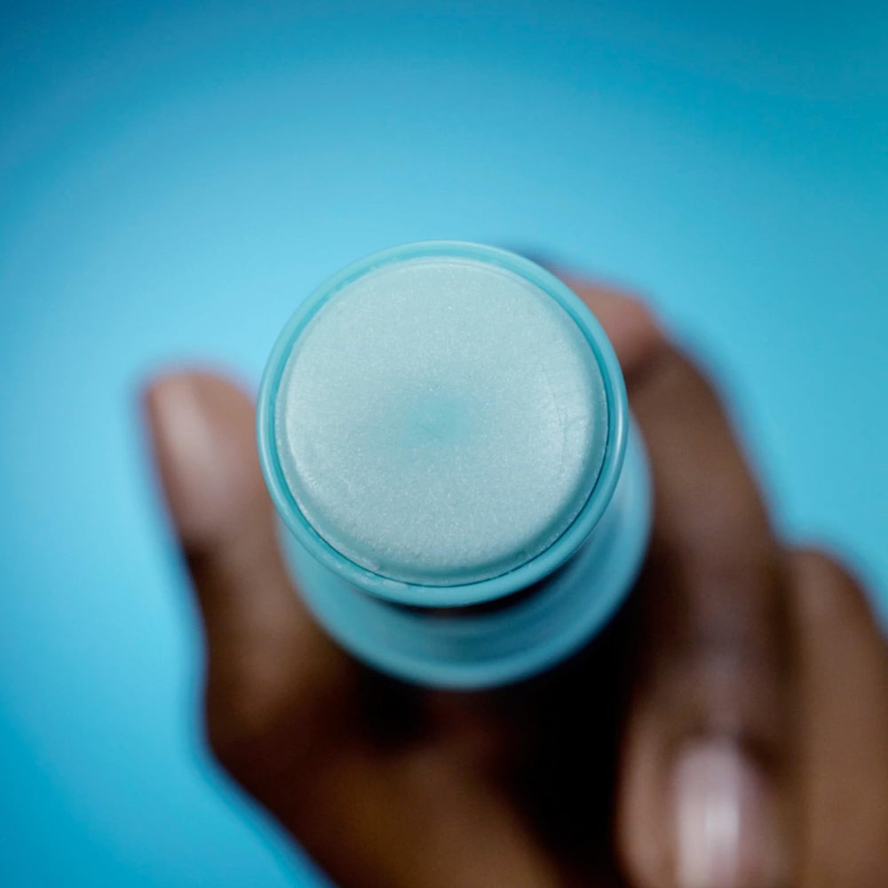 TULA eye balm in hand demonstrating easy swipe application and mess-free portability