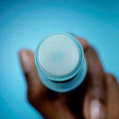 TULA eye balm in hand demonstrating easy swipe application and mess-free portability