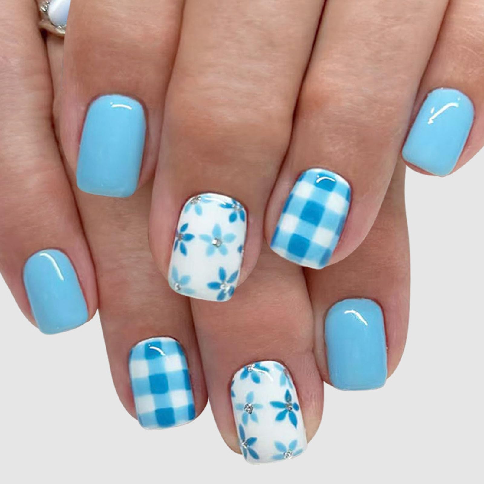 TUZANDW front packaging showing blue white floral nails and included tools for convenience