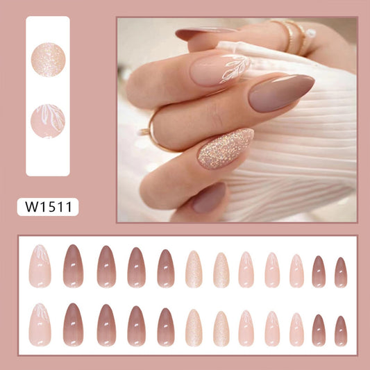 Tyuimhx close-up of leaf pattern and glitter on a nail showcasing glossy decorative detail