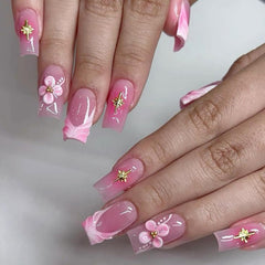 Tyuimhx charms beside a coin to illustrate scale and precision for delicate nail art