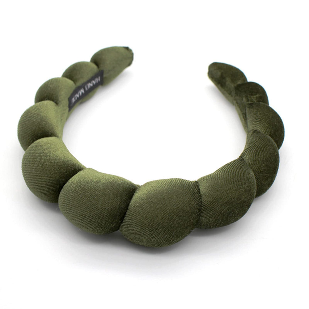 Uchyius headband front view showing leaf green velvet and polished look