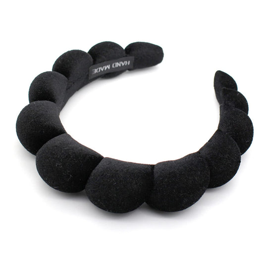 Uchyius headband front view showing sleek velvet finish and elegant style benefit