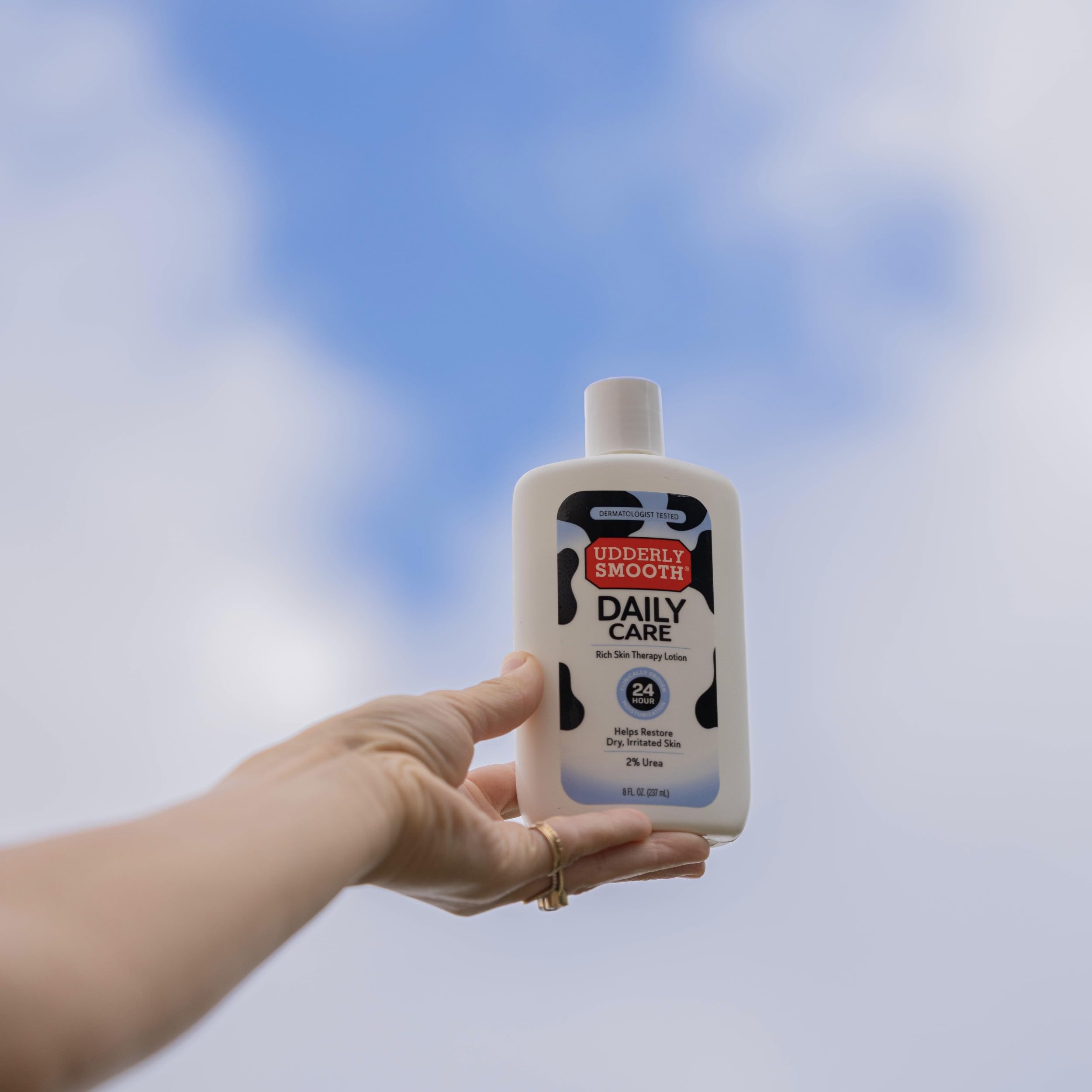 UDDERLY SMOOTH bottle on bathroom shelf in lifestyle scene showing daily-care benefit