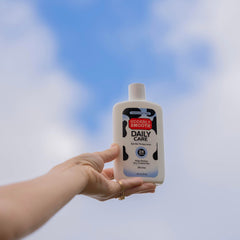 UDDERLY SMOOTH bottle on bathroom shelf in lifestyle scene showing daily-care benefit