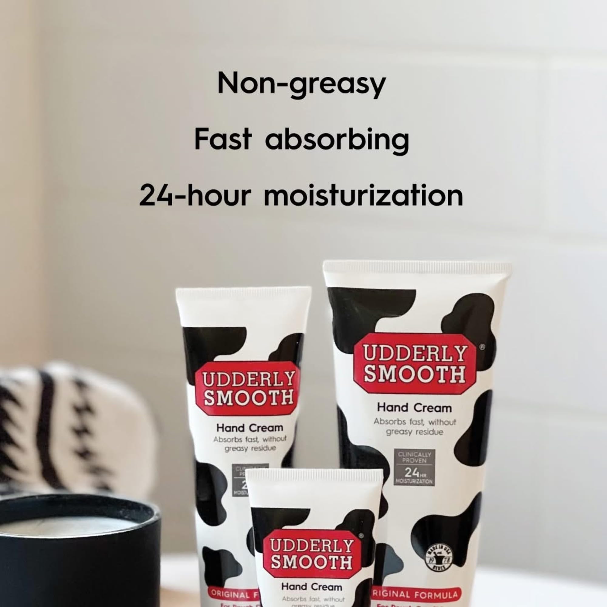 Udderly Smooth bundle held in hand illustrating travel-friendly size