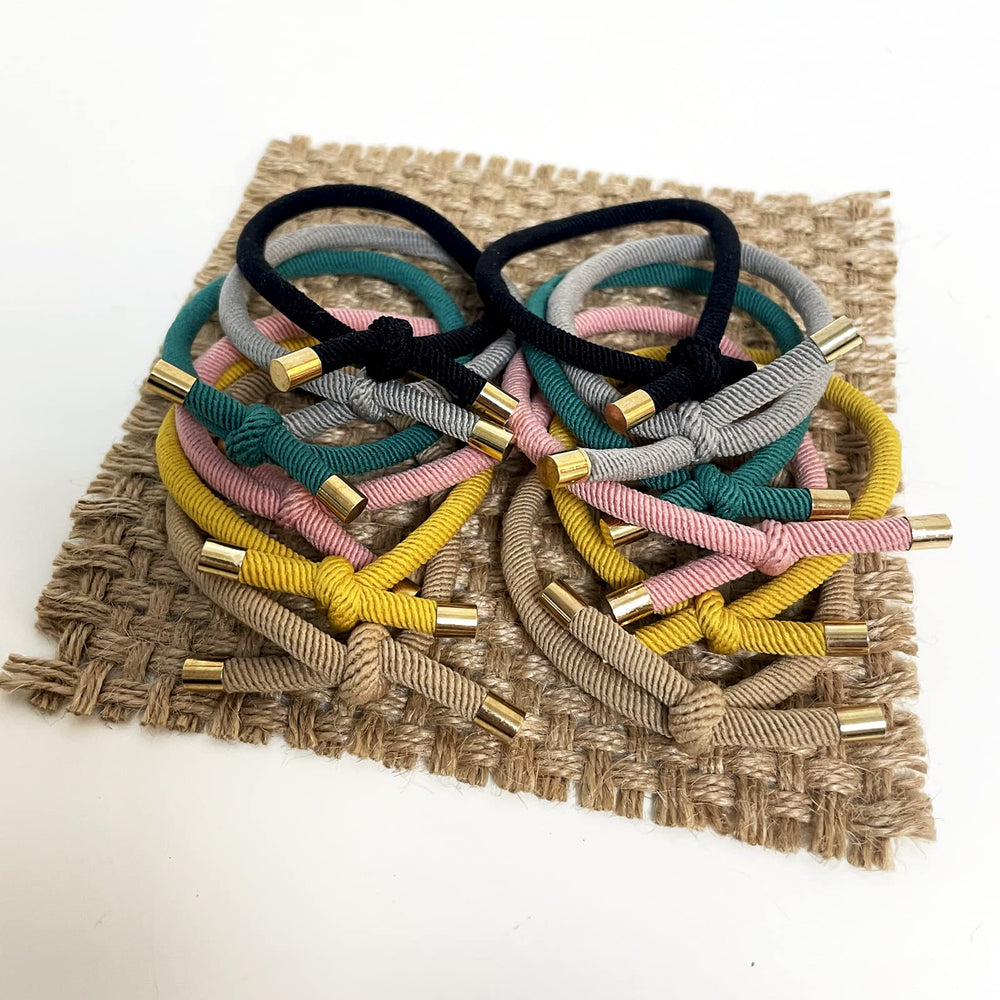 UDeBe hair tie held in hand for size and scale, showing easy portability