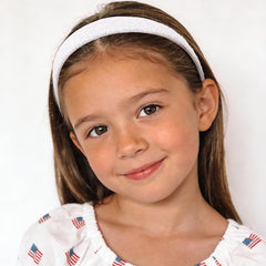 Uintoon headband worn by girl at parade demonstrating secure comfortable hold