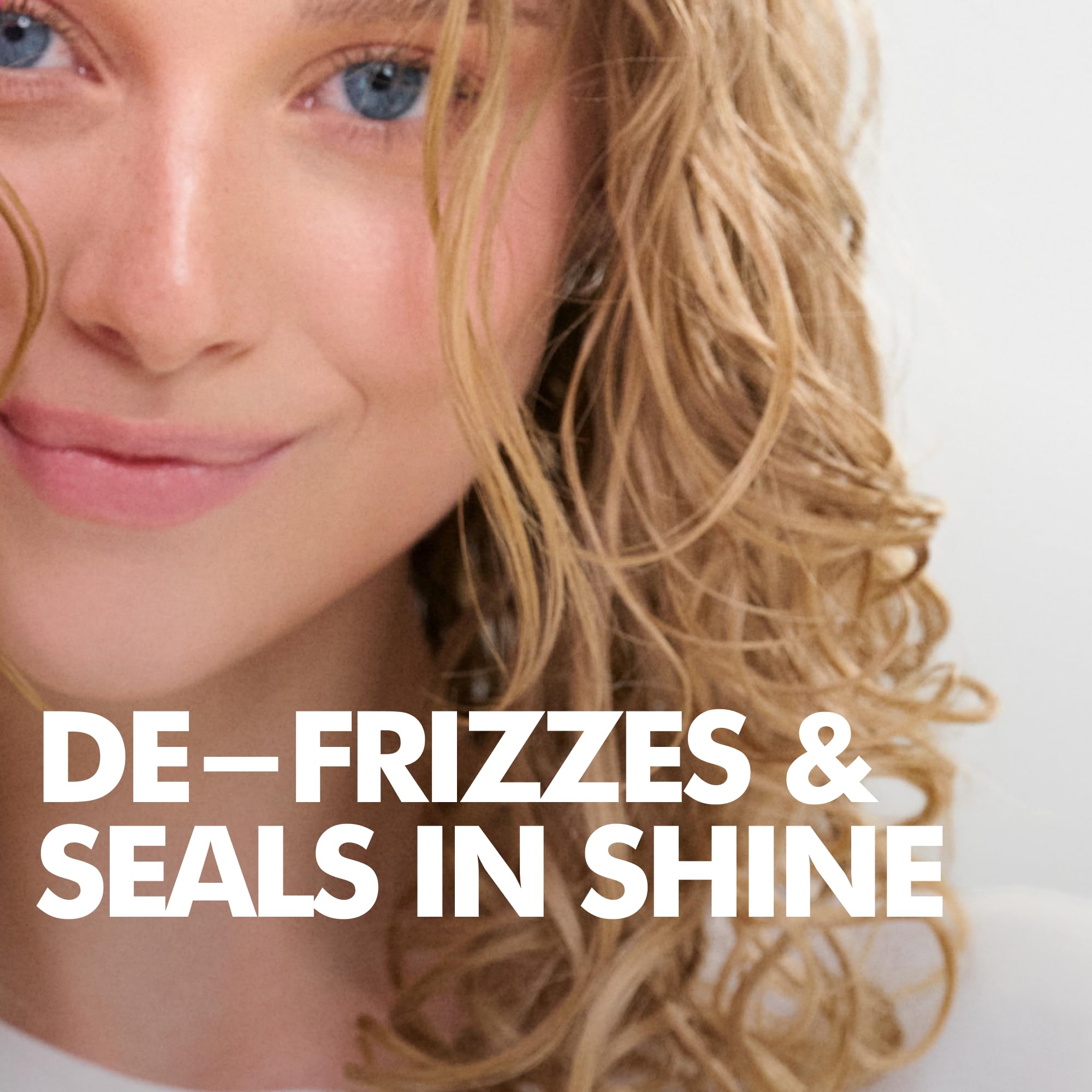 Umberto Giannini conditioner being applied to curls to detangle and hydrate