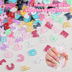 Umillars letters beside a coin showing scale to judge charm size for nails and crafts