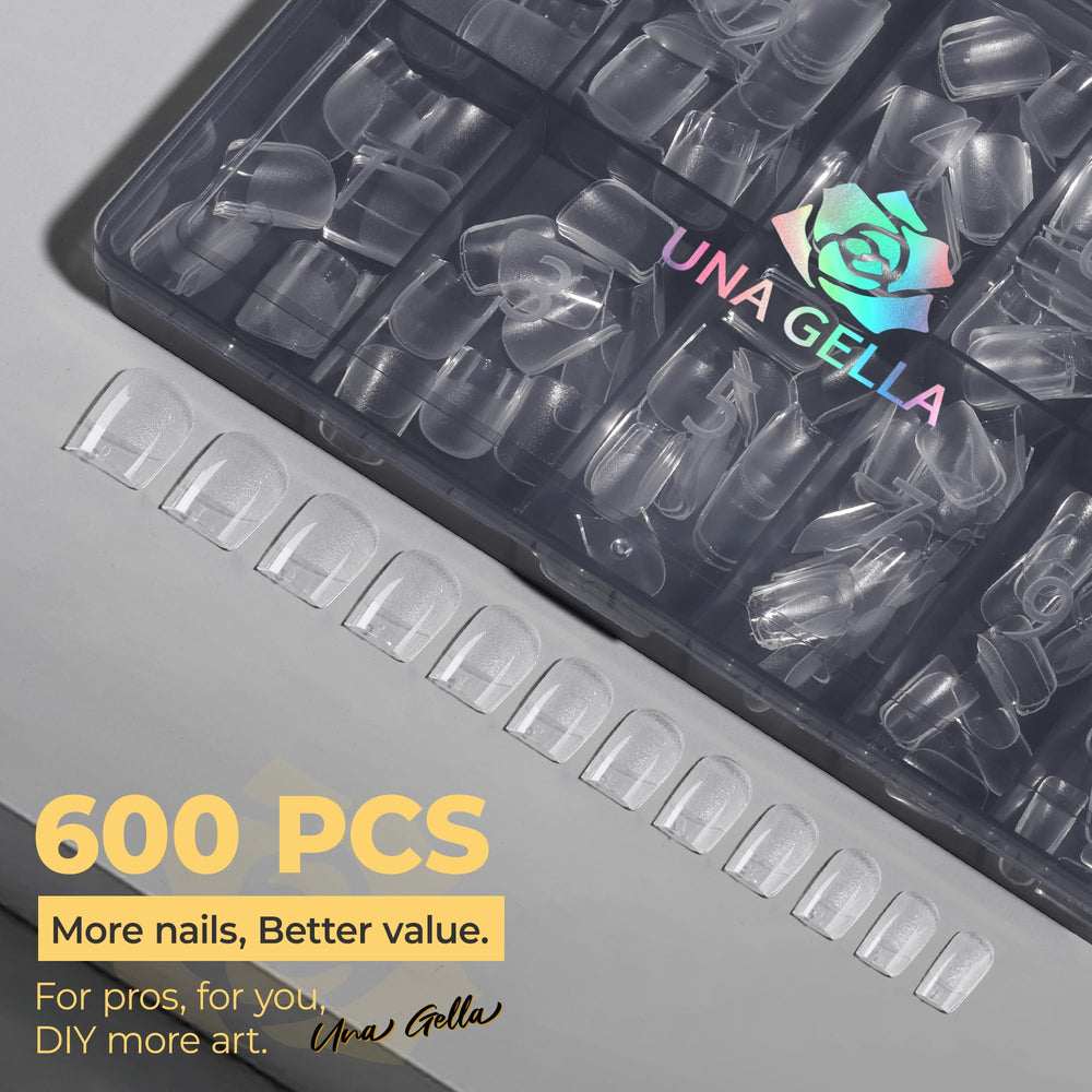 UNA GELLA lifestyle shot typing at a desk with short square nails