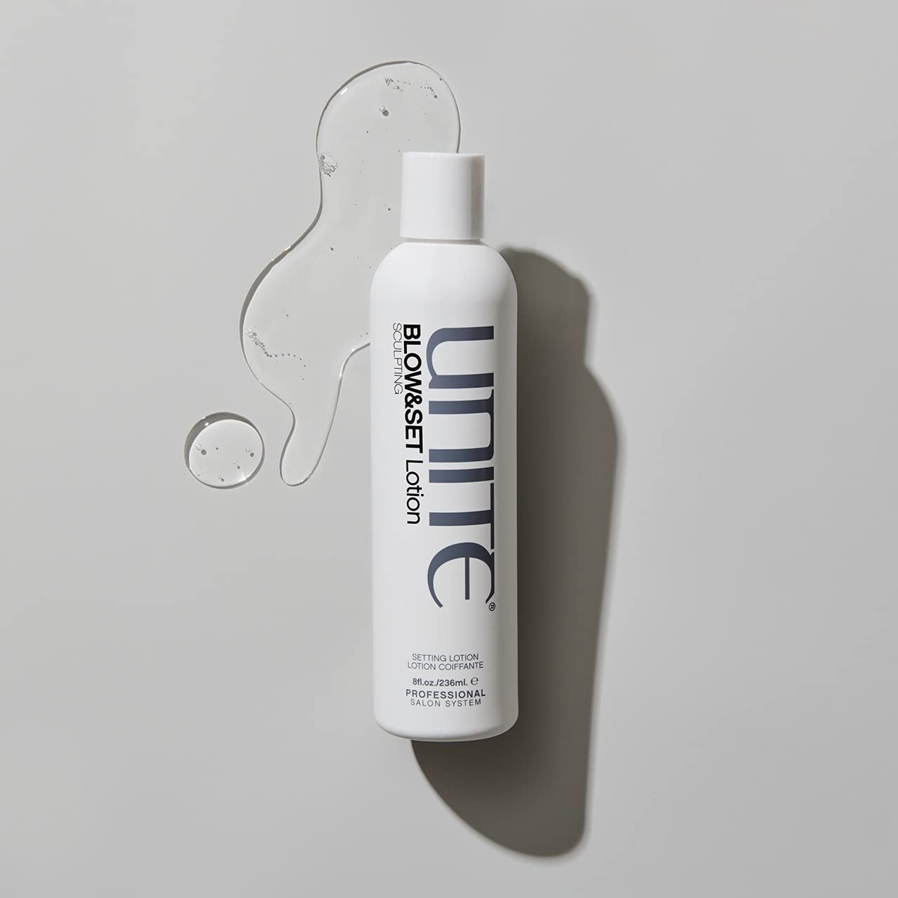 UNITE BLOW&SET bottle next to ruler showing the 8 fl oz size for reference