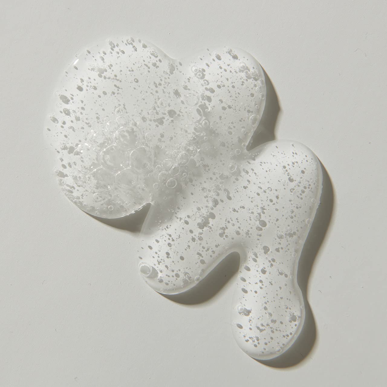 UNITE BLOW&SET lotion dispensed on hand showing lightweight texture and control